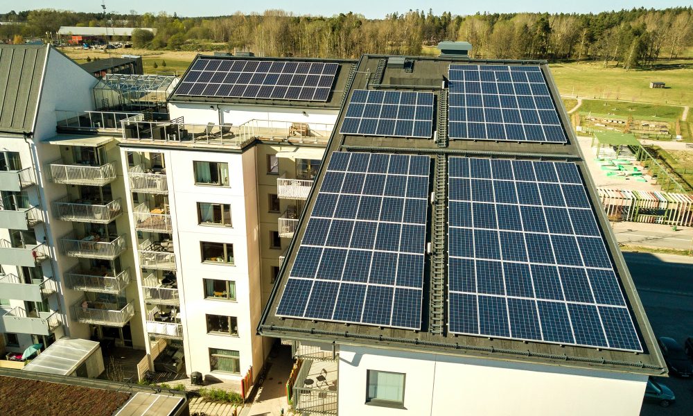 Aerial view of solar photovoltaic panels on a roof top of residential building block